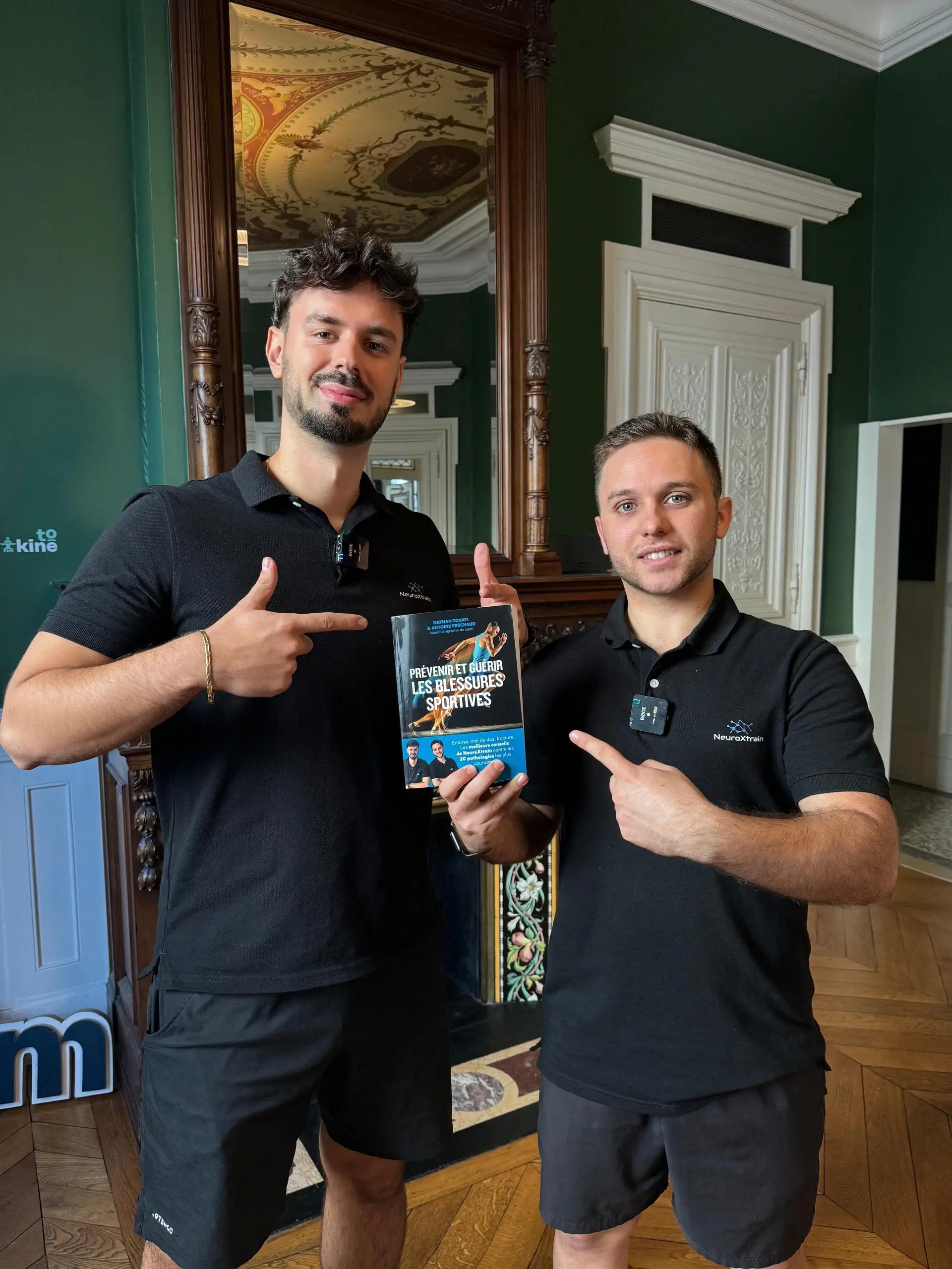NeuroXtrain founders holding book